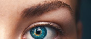 Closer visual of bluish greenish eye