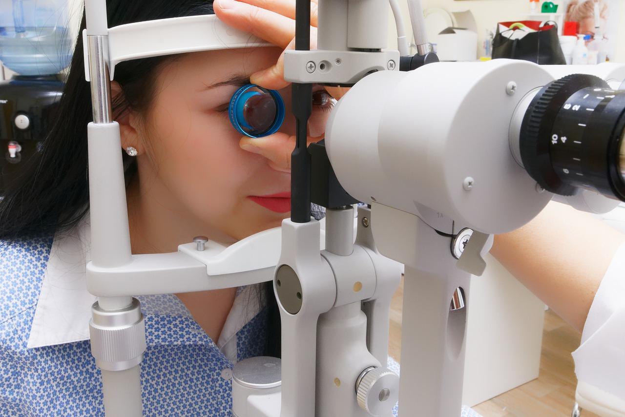 Ophthalmologist examining a patient using a modern equipment