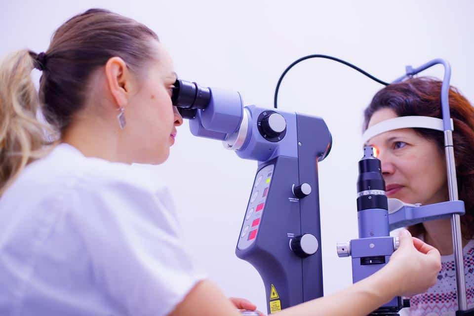An elderly patient being examined using an optical equipment