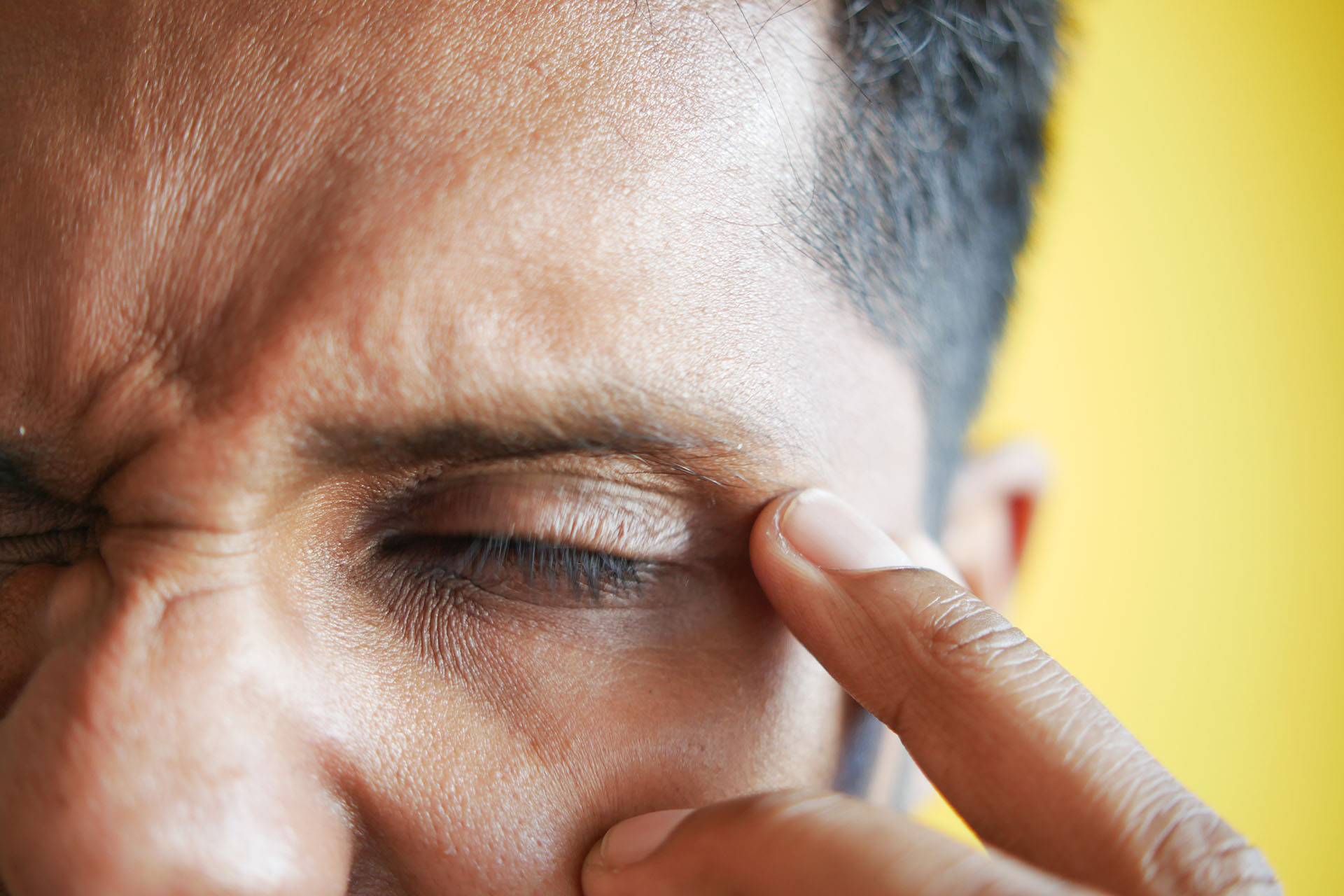 A man experiencing pain with an eye condition