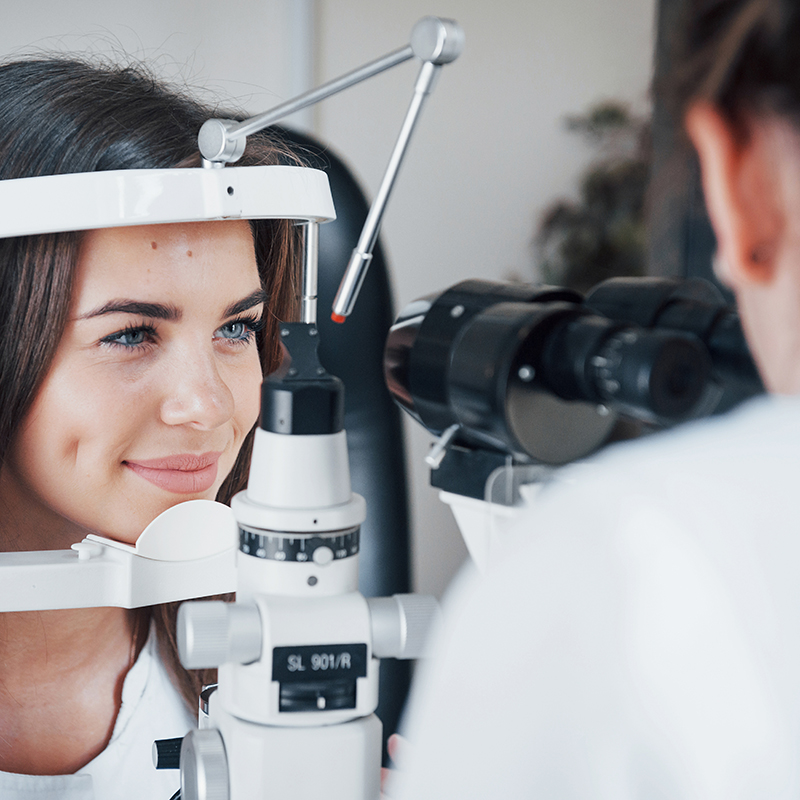 Optometrist checking female patient's vision at eye care center in Las Vegas